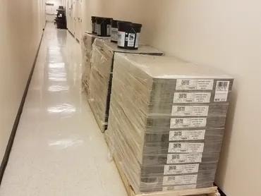 Adma Biologics hallway with stacked flooring material boxes before installation