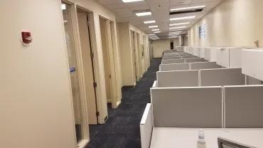 Adma Biologics long office corridor with cubicles before new flooring