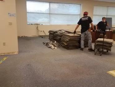 Adma Biologics crew stacking removed old carpet tiles