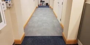 Adma Biologics finished hallway with new gray vinyl tile flooring