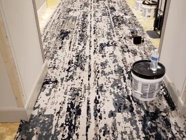 Tequesta Point Condominium hallway with new carpet and adhesive cans